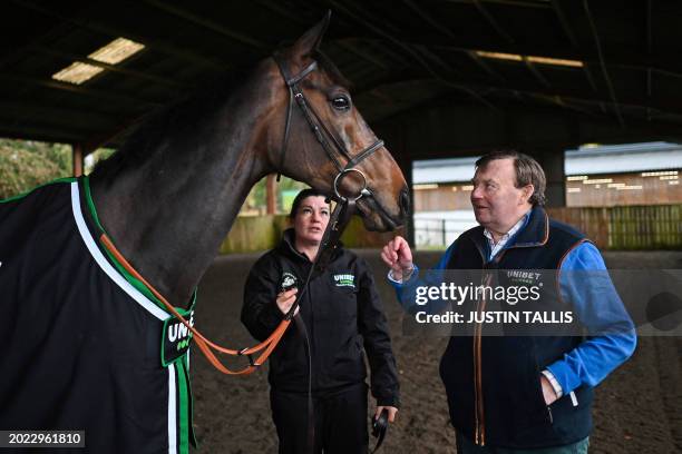Racehorse trainer Nicky Henderson poses for a photograph with horse Constitution Hill during a photo call at Seven Barrows, near Lambourn in southern...