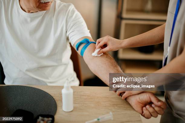 nurse is taking a patient's blood - blood donation stock pictures, royalty-free photos & images