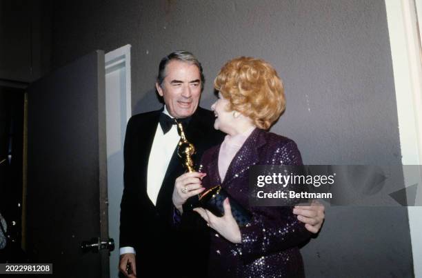 American actor Gregory Peck with comedienne Lucille Ball who was honoured with the Cecil B DeMille Award at the 36th Annual Golden Globe Awards at...