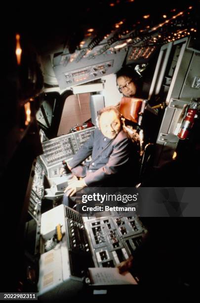 Chinese Vice Premier Deng Xiaoping seated at the controls of NASA's Space Shuttle Orbiter simulator during a visit to the Johnson Space Center in...