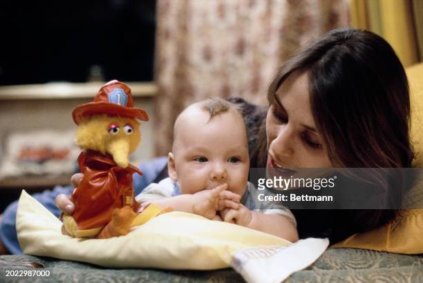 Firefighter Linda Eaton with her baby son Ian, aged four months, at their home in Iowa City, January 30th 1979. Eaton was dismissed by the Iowa City...