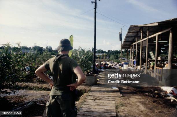 Military personnel during the recovery of dead bodies at the Peoples Temple compound in Jonestown, Guyana, November 25th 1978. Under the direction of...