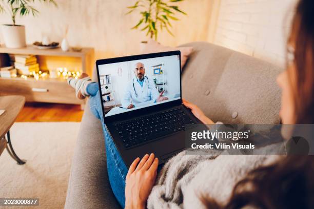 a woman having video call with doctor - serbia covid stock pictures, royalty-free photos & images