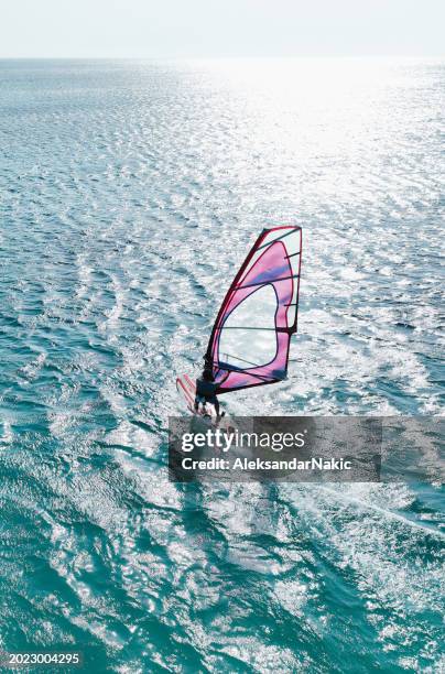 wind surfing on the sea - windsurfing stock pictures, royalty-free photos & images