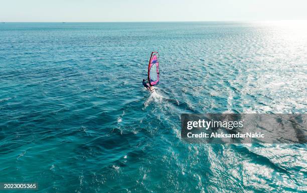 wind surfing on the sea - windsurfing stock pictures, royalty-free photos & images