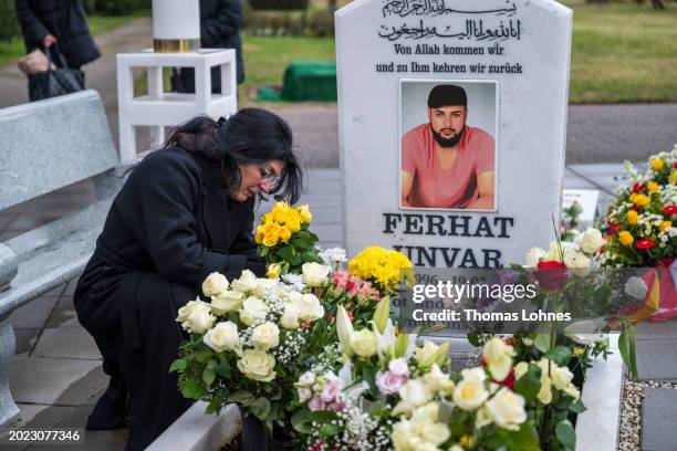 Serpil Unvar, relatives and friends pray at Ferhat Unvar's grave and the memorial for the nine victims of the 2020 Hanau mass shooting on its fourth...
