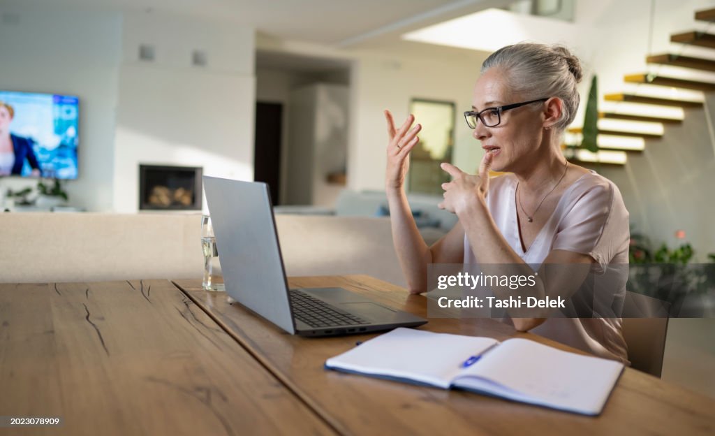 Woman Attending Online Videocall At Home