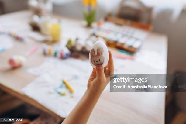 decorated easter egg in child's hand - christian school stock pictures, royalty-free photos & images