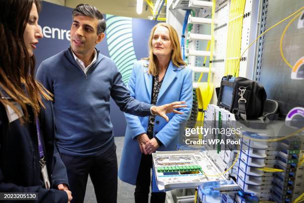 British Prime Minister Rishi Sunak looks at fibre optic cables, during a visit to an Openreach exchange on February 22, 2024 in Anglesey, Wales.