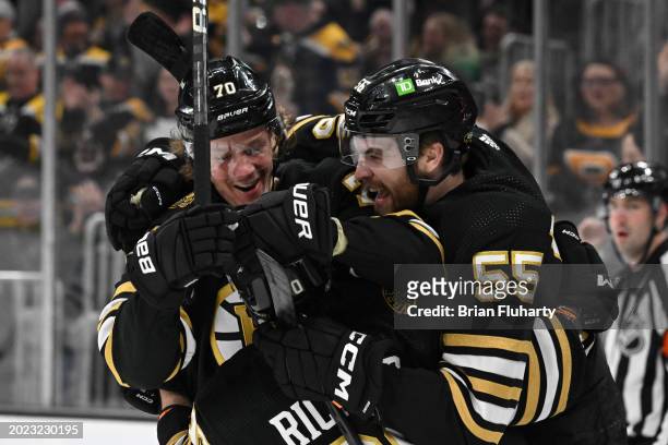 Jesper Boqvist of the Boston Bruins celebrates with Justin Brazeau and Anthony Richard after scoring a goal against the Dallas Stars during the first...