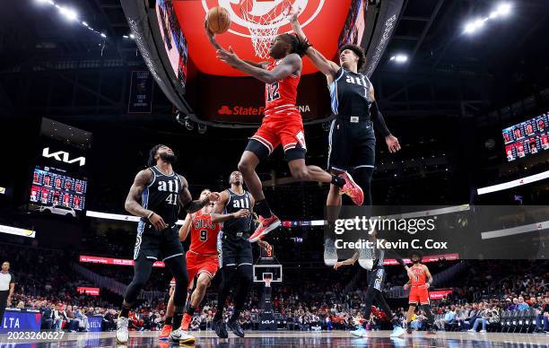 Ayo Dosunmu of the Chicago Bulls drives against Jalen Johnson of the Atlanta Hawks during the first quarter at State Farm Arena on February 12, 2024...