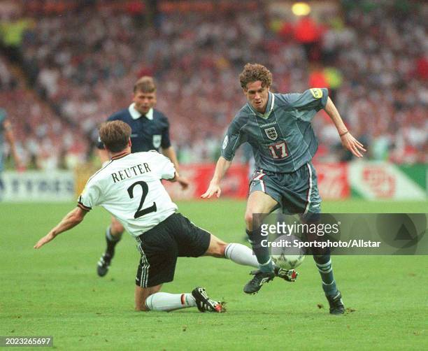 June 26: Steve Mcmanaman of England and Stefan Reuter of Germany challenge during the UEFA Euro 1996 Semi Final match between Germany and England at...