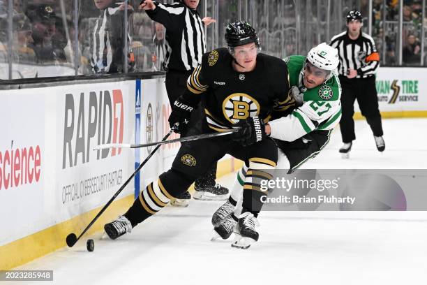 Trent Frederic of the Boston Bruins controls the puck against Mason Marchment of the Dallas Stars during the first period at the TD Garden on...