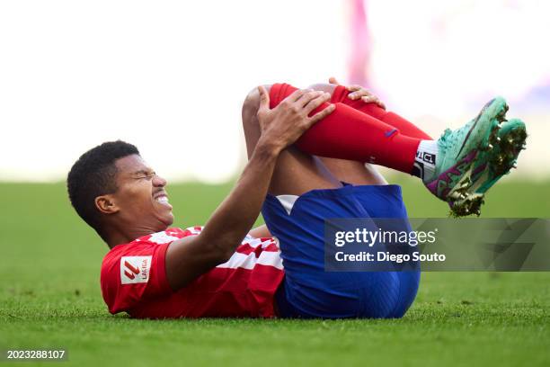 Reinildo Mandava of Atletico de Madrid lies injured on the pitch during the LaLiga EA Sports match between Atletico Madrid and UD Las Palmas at...