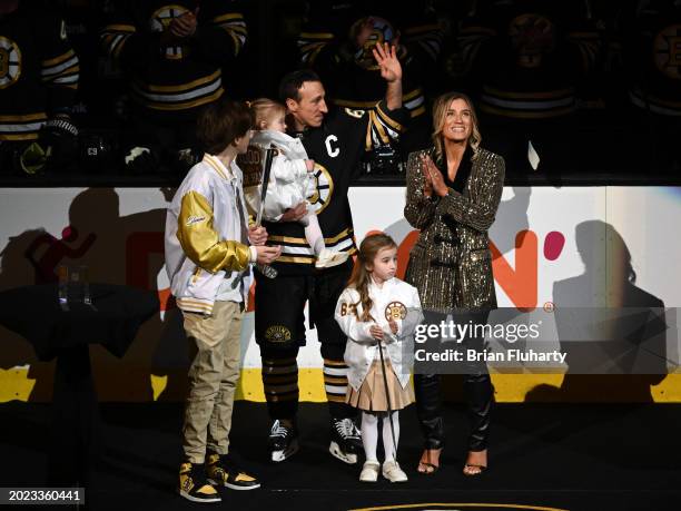 Brad Marchand of the Boston Bruins waves to the crowd during a pregame ceremony celebrating 1,000 NHL games played, before a game against the Dallas...