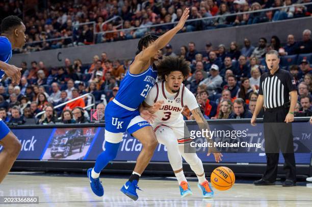 Tre Donaldson of the Auburn Tigers looks to maneuver the ball by D.J. Wagner of the Kentucky Wildcats at Neville Arena on February 17, 2024 in...