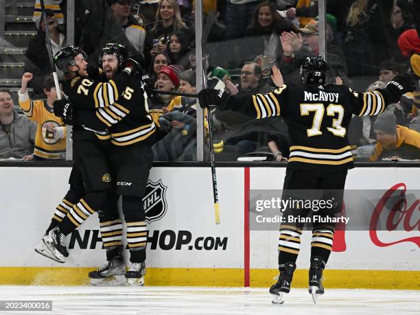 Justin Brazeau of the Boston Bruins celebrates with Jesper Boqvist after Charlie McAvoy after scoring his first NHL game against the Dallas Stars...