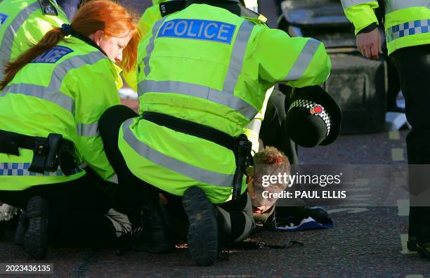 Police officers arrest a Roma's fan as Manchester United's fans clashed with AS Roma's before their European Champions League quarter final second...