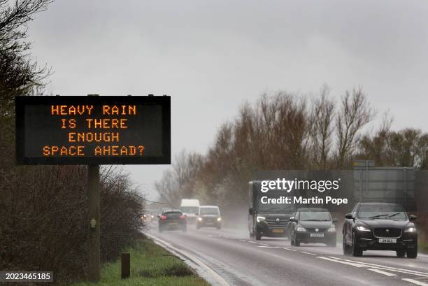 Road sign warns drivers to keep their distance in the heavy rain on the A142 on February 22, 2024 in Ely, United Kingdom. The Met Office has issued a...