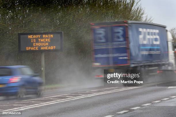 Road sign warns drivers to keep their distance in the heavy rain on the A142 on February 22, 2024 in Ely, United Kingdom. The Met Office has issued a...