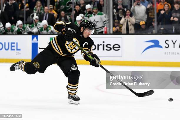 Brad Marchand of the Boston Bruins shoots and scores during a shootout against the Dallas Stars period at the TD Garden on February 19, 2024 in...