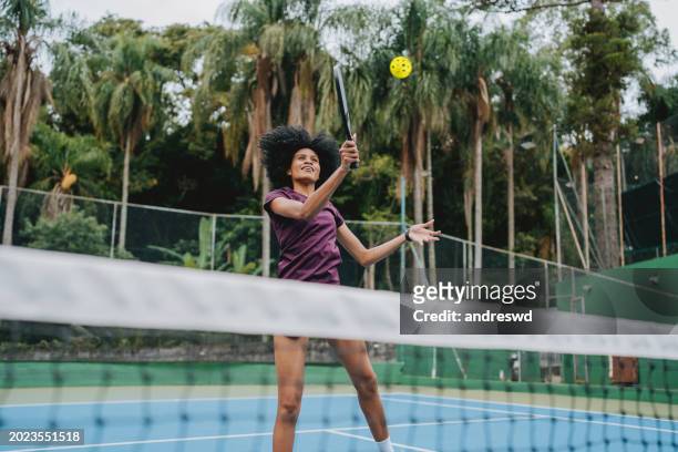 woman playing pickleball - tennis ball hand stock pictures, royalty-free photos & images