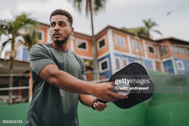 man playing pickleball serve - athlete stock pictures, royalty-free photos & images