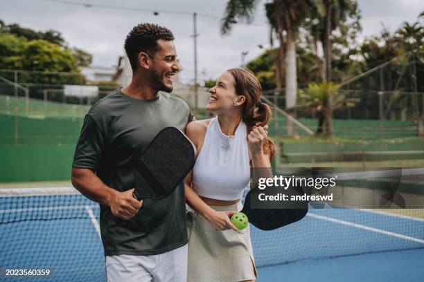 couple playing pickleball celebrate point - paddle ball stock pictures, royalty-free photos & images