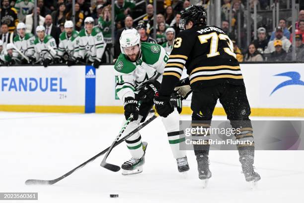 Charlie McAvoy of the Boston Bruins defends Tyler Seguin of the Dallas Stars during an overtime period at the TD Garden on February 19, 2024 in...