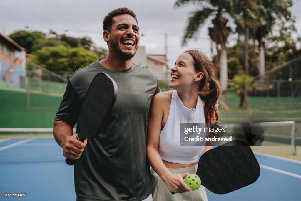 Couple playing pickleball celebrate point