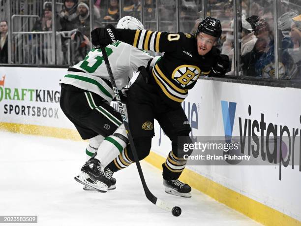 Jesper Boqvist of the Boston Bruins controls the puck against Wyatt Johnston of the Dallas Stars during the third period at the TD Garden on February...