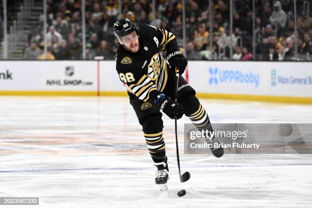 David Pastrnak of the Boston Bruins takes a shot against the Dallas Stars during an overtime period at the TD Garden on February 19, 2024 in Boston,...