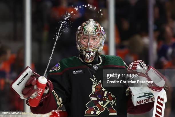 Goaltender Matt Villalta of the Arizona Coyotes sprays water from his bottle during the first period of the NHL game against the Edmonton Oilers at...