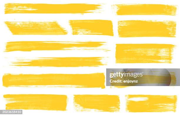 gelbe pinselstrichvektoren - farbstreifen stock-grafiken, -clipart, -cartoons und -symbole