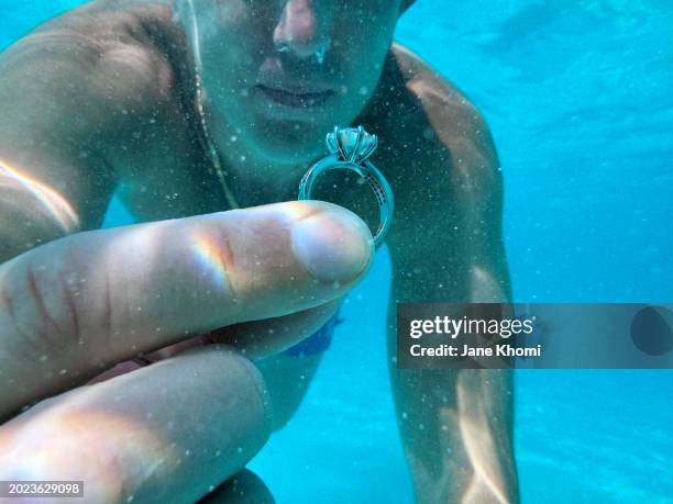 young man doing underwater proposal - verlobung stock-fotos und bilder