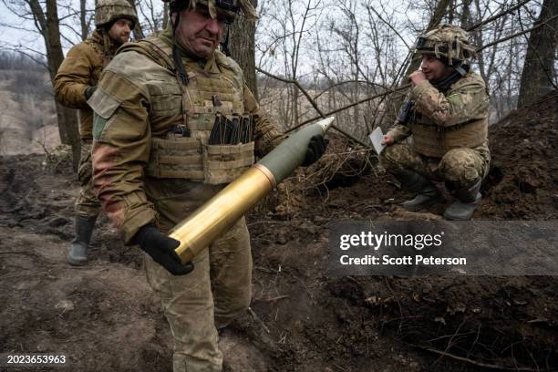 Ukrainian soldier who gave the name Ruslan loads the gun, as soldiers of the Ukraine Armys 95th Brigade fire 105mm artillery shells from a...