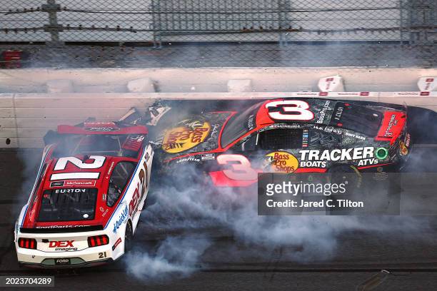 Harrison Burton, driver of the Motorcraft/DEX Imaging Ford, and Austin Dillon, driver of the Bass Pro Shops Chevrolet, spin after an on-track...
