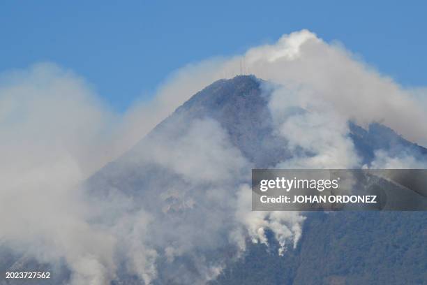 Smoke billows from wildfires on the slopes of the Agua Volcano, as seen from Villa Nueva, Guatemala, on February 22, 2024. A voracious forest fire is...