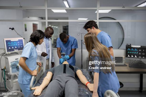 medical students intubating a dummy at a teaching hospital - estudante de medicina imagens e fotografias de stock