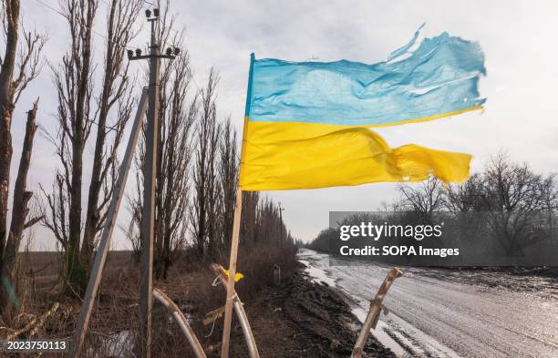 Torn but proudly flying flag is seen along a road in the Donetsk region, a symbol of a free Ukraine.