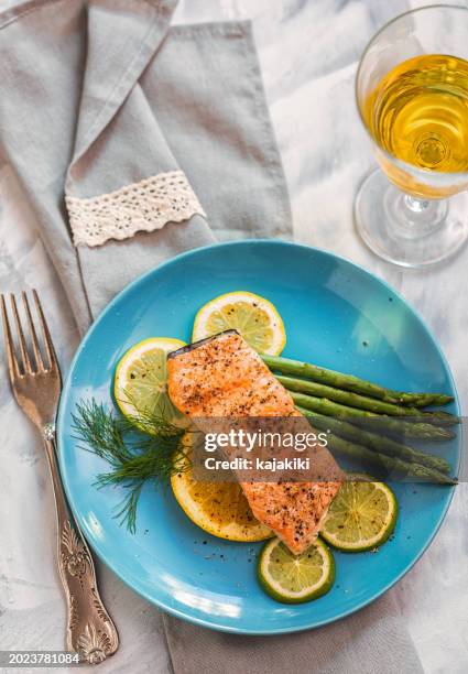 grilled fillet of salmon with asparagus served on a plate - salmon steak stock pictures, royalty-free photos & images