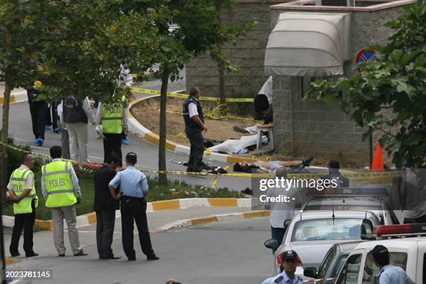 Unidentified men lie on the ground lifeless after an attack outside the US consulate in Istanbul on July 9, 2008. Three unidentified gunmen and three...