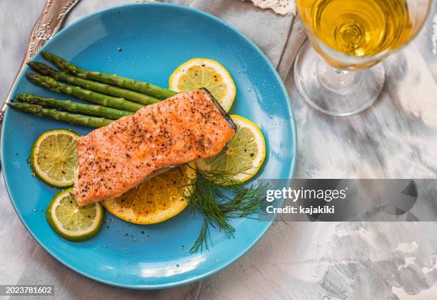 grilled fillet of salmon with asparagus served on a plate - gebackener lachs stock-fotos und bilder