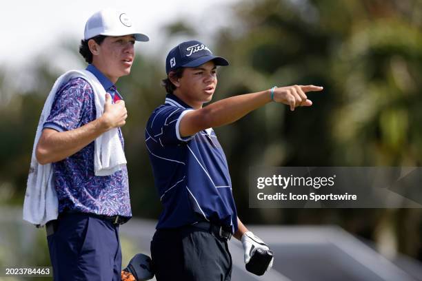 Charlie Woods, son of Tiger Woods, talks with friend and caddie J.J. Kutner during pre-qualifying for The Cognizant Classic in The Palm Beaches at...