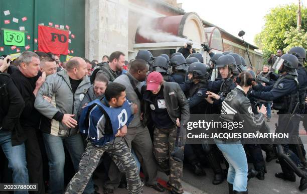 Prison guards blocking access to the prison in Fleury-Merogis, outside of Paris, are sprayed with tear gas by French police on May 4, 2009 during a...