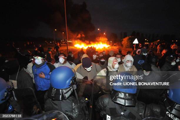 French anti-riot police face prison guards blocking in front of the Fleury-Merogis prison late on May 5, 2009 on the second day of protests against...