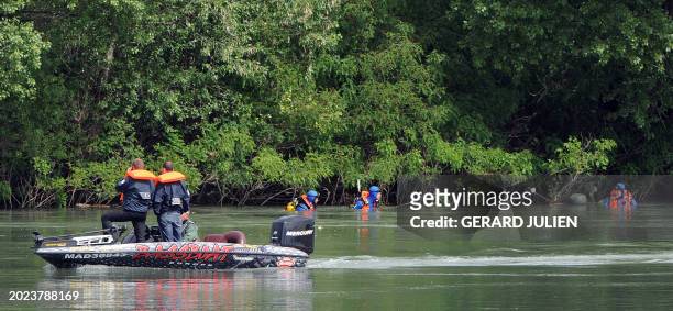 French police divers search a canal along the river Rhone on May 15, 2009 in Tarascon, southern France, after a German tourist went missing a day...