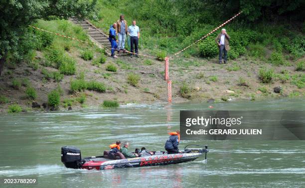 French police divers search a canal along the river Rhone on May 15, 2009 in Tarascon, southern France, after a German tourist went missing a day...