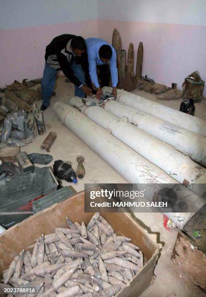 Iraqi police take stock of munitions and homemade bombs at the local police station in the northern city of Tikrit, some 180 kms from Baghdad on...