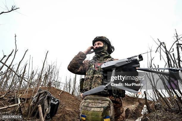 Serviceman from the 65th Separate Mechanized Brigade of the Land Forces of the Armed Forces of Ukraine is launching a drone into the sky near...